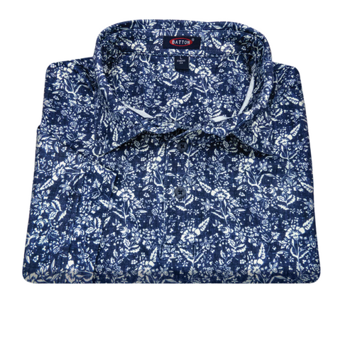 Folded blue floral pattern shirt with 'Barton' label on a white background