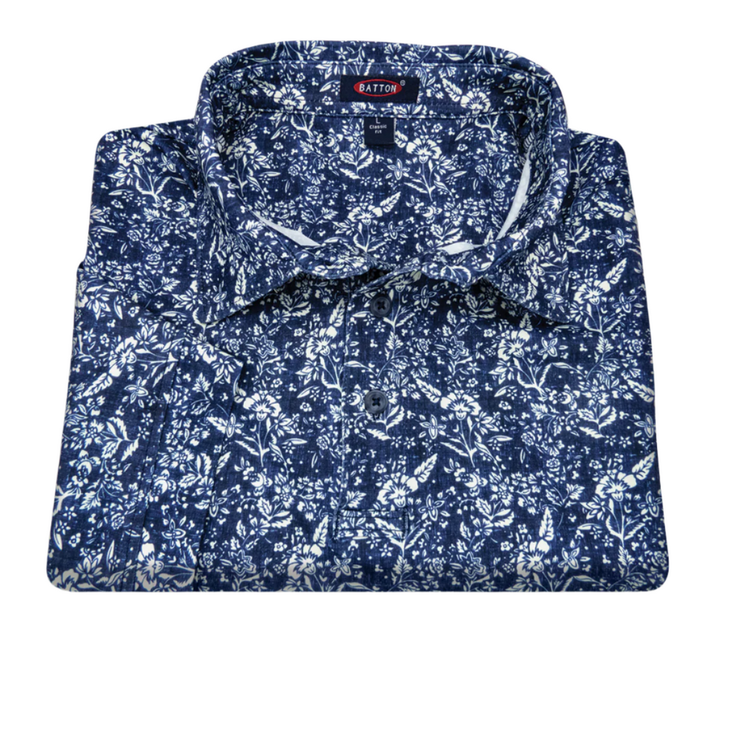 Folded blue floral pattern shirt with 'Barton' label on a white background