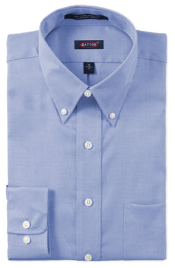 Folded light blue dress shirt with button details on a white background