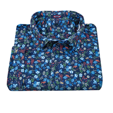 A short-sleeved polo shirt with a floral pattern in navy, arctic, and coral colors, featuring a crew neckline and a three-button placket.