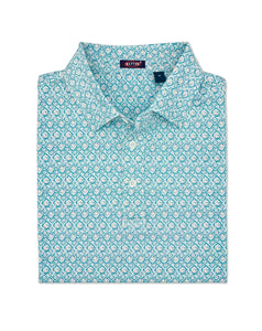Folded blue patterned shirt with a brand label on a white background